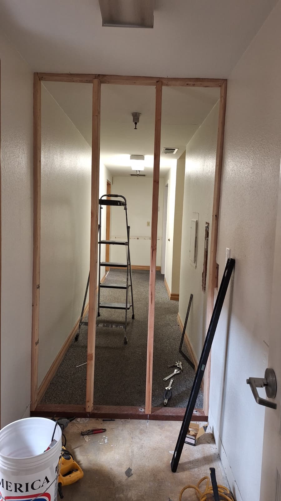 Wood framing of a new wall in a hallway