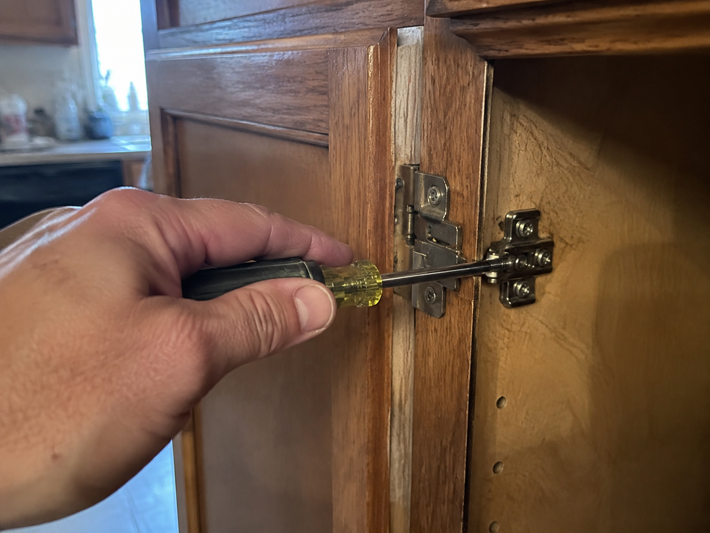 Handyman using a drill on an interior door