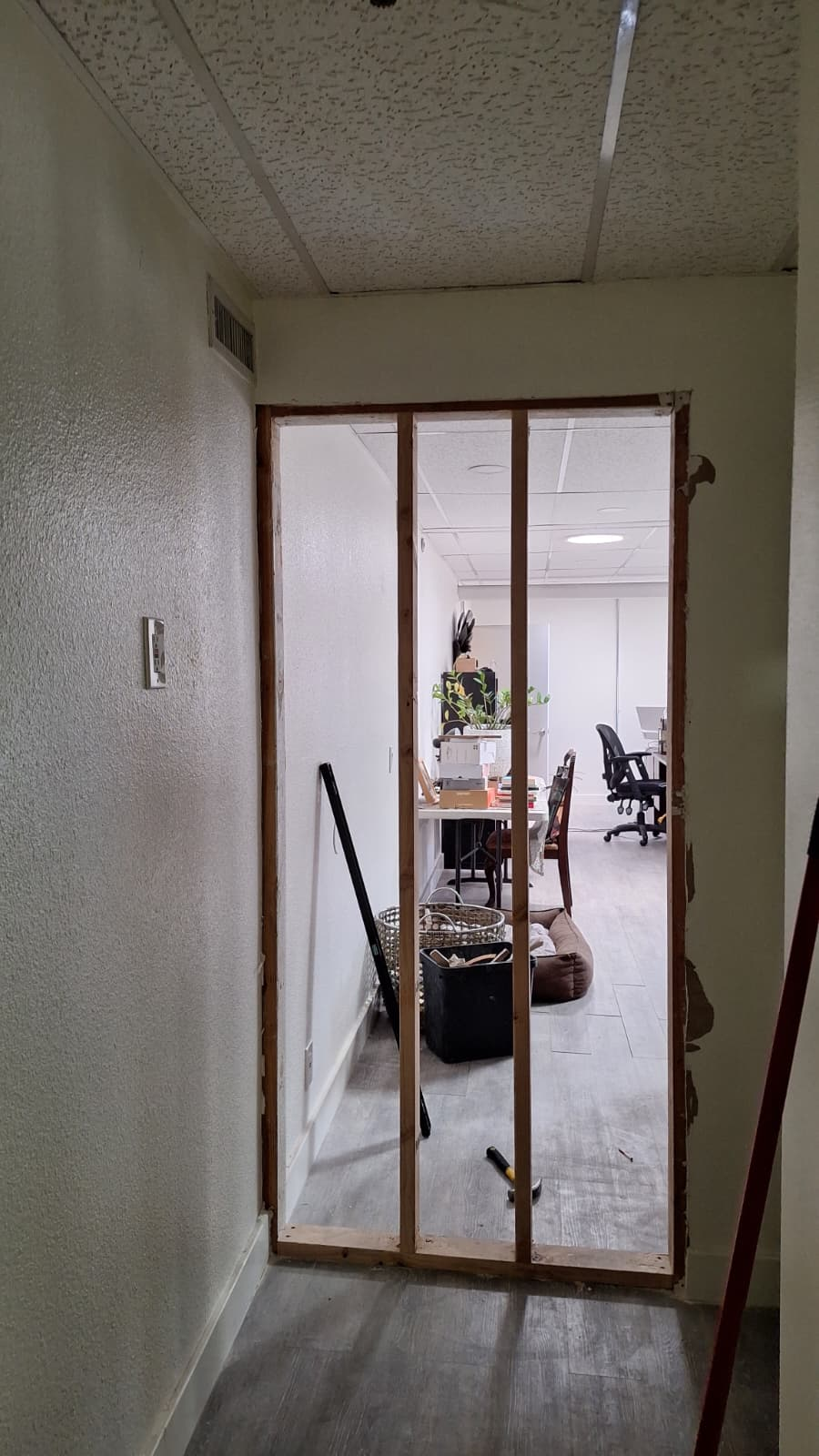 Wall framing with an open view into an office